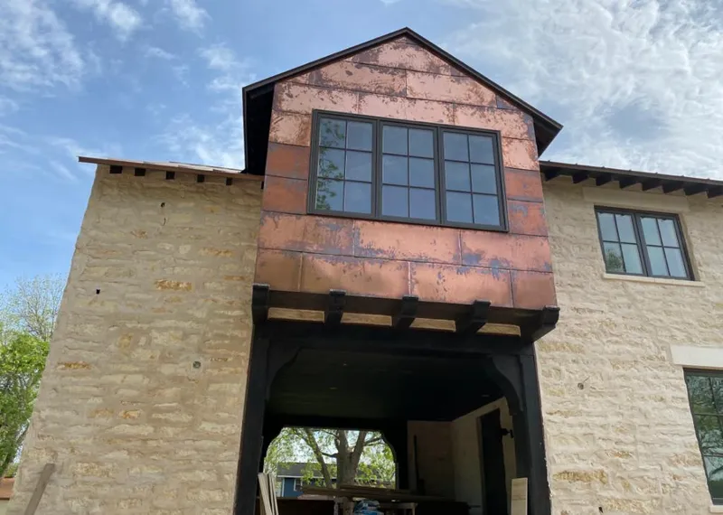 Copper metal panel facade on a stone building for Skylight Installation in Pine Bluff