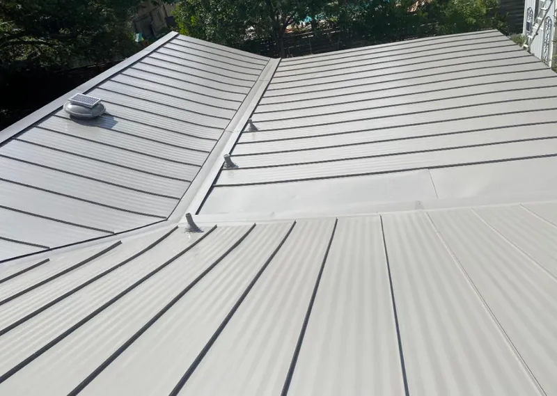 Solar attic fan installed on a metal roof for Roof Ventilation in Pine Bluff